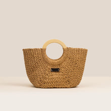 Load image into Gallery viewer, Woven handbag with wooden handle on a beige background
