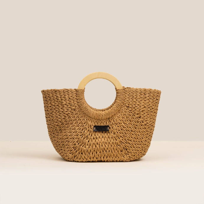 Woven handbag with wooden handle on a beige background