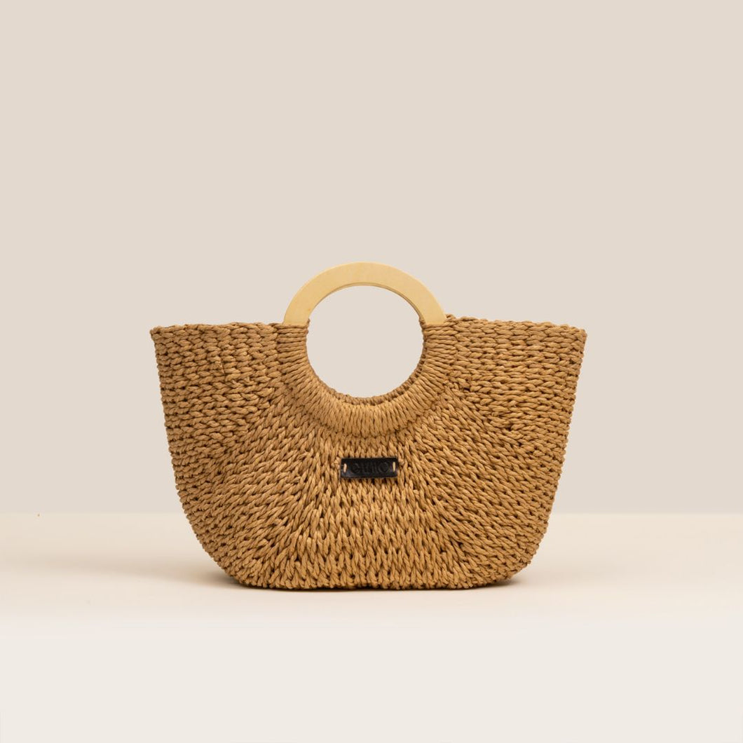 Woven handbag with wooden handle on a beige background