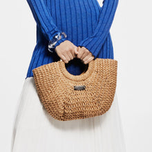 Load image into Gallery viewer, Person holding a woven handbag with a plain background
